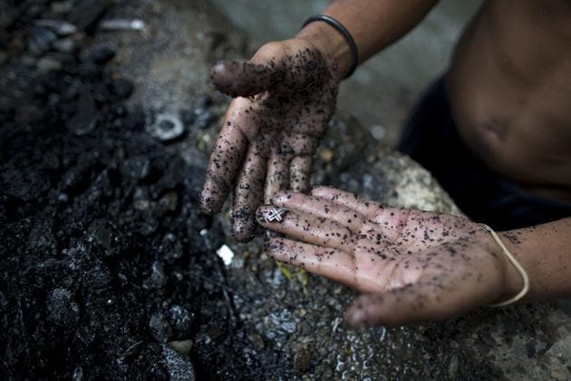 A scavenger shows his haul from the Guaire river bottom, where men search for bits of precious metal to cash in for food. Nearly two decades of socialist rule have seen Venezuela’s food and oil production plummet amid poor management of state resources, and a drop in world crude prices has driven many to desperate means for livelihoods. (Ariana Cubillos / AP) A scavenger shows his haul from the Guaire river bottom, where men search for bits of precious metal to cash in for food. Nearly two decades of socialist rule have seen Venezuela’s food and oil production plummet amid poor management of state resources, and a drop in world crude prices has driven many to desperate means for livelihoods. (Ariana Cubillos / AP)