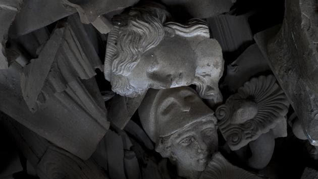 Two terracotta busts of a Caryatid and the ancient Greek goddess of wisdom, Athena, are seen among other broken pieces in Haralambos Goumas' workshop. Over the past half-century, he has produced thousands of terracotta statues of ancient Greek deities, mythical figures and fabulous beasts, mostly for use as architectural and garden ornaments. (Petros Giannakouris / AP)