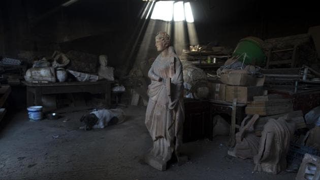 A dog lies next to a terracotta statue of Erato, one of the nine Muses of ancient Greek mythology. Most of Goumas’ works draw from the neoclassical tradition that dominated Greek urban architecture from the 1830s to the 1920s, and was blitzed during unbridled post-World War II redevelopment. (Petros Giannakouris / AP)