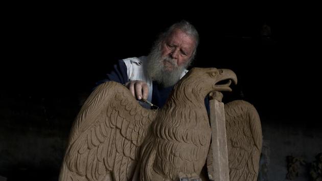 Haralambos Goumas works on a terracotta eagle, at his workshop. Once rejected as trite remnants of an irrelevant past, the original neoclassical terracotta statues that decorated facades, niches and pediments are now highly-prized antiques. (Petros Giannakouris / AP)