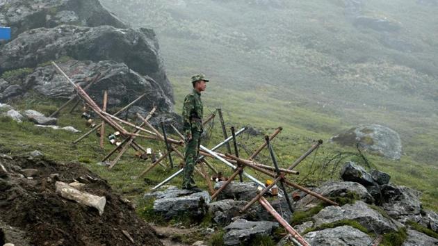 A Chinese soldier stands guard on the Chinese side of the ancient Nathu La border crossing between India and China. (AFP File Photo) A Chinese soldier stands guard on the Chinese side of the ancient Nathu La border crossing between India and China. (AFP File Photo)