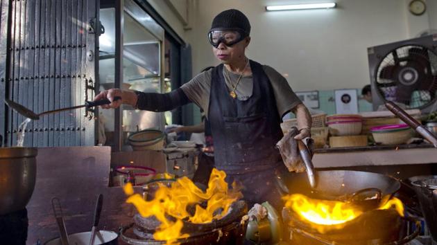 After spending more than three decades cooking in an unassuming outdoor kitchen, wok-wielding, goggles-wearing Thai chef Supinya Jansuta has been propelled to international culinary stardom by having her restaurant ‘Jay Fai’ awarded a Michelin star. (Gemunu Amarasinghe / AP)