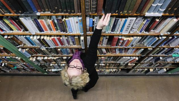 Assistant Librarian, Anna Goodridge straightens the books in the shelves. The Leeds Library’s collection is particularly rich in travel, topography, biography, history and literature. (Ian Forsyth / Getty Images)