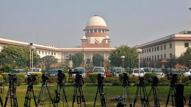 A television journalist sets his camera inside the premises of the Supreme Court in New Delhi. The top court has the SIT to submit its status report in two months.(Reuters File)