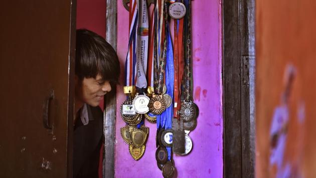 Tiwari takes a ook at his medals in Paharganj, New Delhi. Being an expensive sport, financial assistance for Raj’s training has always been a problem. In September 2016, a life insurance company sponsored and sent him to the US for advanced training. (Raj K Raj / HT Photo) Tiwari takes a ook at his medals in Paharganj, New Delhi. Being an expensive sport, financial assistance for Raj’s training has always been a problem. In September 2016, a life insurance company sponsored and sent him to the US for advanced training. (Raj K Raj / HT Photo)