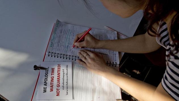 A customer writes her name on a waiting list for a table at the 72-year-old Supinya Jansuta’s restaurant. With waiting times running into several hours, the joint’s newfound fame means that even landing a table isn’t guarantee of immediate service at this family run eatery. (Gemunu Amarasinghe / AP)