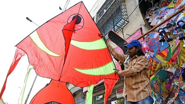 A shopkeeper shows off a huge fish-shaped kite at his shop in Bandra. (Satyabrata Tripathy/HT Photo)