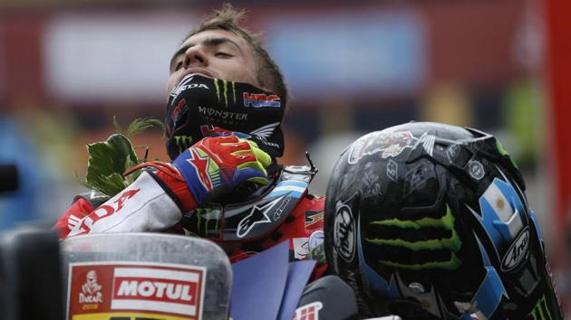 Honda motorbike rider Kevin Benavides of Argentina fixes his neckerchief upon arrival in La Paz, Bolivia, after completing the Dakar Rally stage 6 on Thursday. (AP) Honda motorbike rider Kevin Benavides of Argentina fixes his neckerchief upon arrival in La Paz, Bolivia, after completing the Dakar Rally stage 6 on Thursday. (AP)