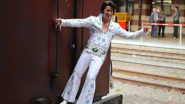 An Elvis Presley impersonator hangs from the Elvis Express before it departs for the Elvis Festival. First held in 1993 to coincide with the singer’s birthday on January 8, 1935, the festival has since placed the town on the tourist map and also earned it the moniker of “Elvis Capital of Australia”. (Daniel Munoz / REUTERS) An Elvis Presley impersonator hangs from the Elvis Express before it departs for the Elvis Festival. First held in 1993 to coincide with the singer’s birthday on January 8, 1935, the festival has since placed the town on the tourist map and also earned it the moniker of “Elvis Capital of Australia”. (Daniel Munoz / REUTERS)