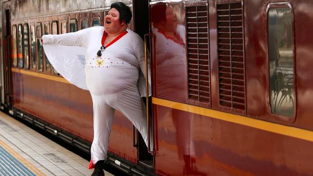 Elvis Presley impersonator Sean Wright poses next to the Elvis Express train at Sydney's Central station before it departs for the 26th annual Elvis Festival being held in the New South Wales town of Parkes in Australia on January 11, 2018. (Daniel Munoz / REUTERS) Elvis Presley impersonator Sean Wright poses next to the Elvis Express train at Sydney's Central station before it departs for the 26th annual Elvis Festival being held in the New South Wales town of Parkes in Australia on January 11, 2018. (Daniel Munoz / REUTERS)