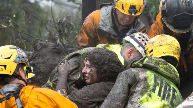 Emergency personnel carry a woman rescued from a collapsed house after a mudslide in Montecito, California on January 9, 2018. (Kenneth Song / Santa Barbara News-Press via REUTERS) Emergency personnel carry a woman rescued from a collapsed house after a mudslide in Montecito, California on January 9, 2018. (Kenneth Song / Santa Barbara News-Press via REUTERS)