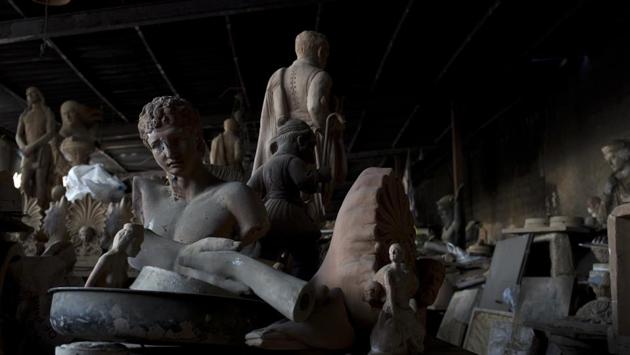 A bust of the ancient Greek messenger of the gods, Hermes (L), stands among other statues and antefixes in Goumas' workshop. Scattered apparently randomly is an Athena here, a horse or a satyr there, among bulls’ heads, griffins, sphinxes, garden urns or busts of the philosopher Socrates and the 19th-century Greek poet Dionysios Solomos. There’s even a Christ somewhere. (Petros Giannakouris / AP)