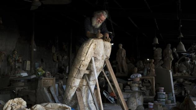Goumas works on a huge terracotta eagle in a mould at his workshop. “I guess that in my lifetime I have made many more statues than those in China’s Terracotta Army,” Goumas told the Associated Press. (Petros Giannakouris / AP)