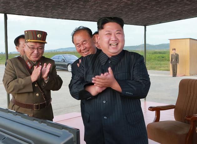 FILE - In this undated file photo distributed on Sept. 16, 2017, North Korean leader Kim Jong Un, right, celebrates what was said to be the test launch of an intermediate range Hwasong-12 missile at an undisclosed location in North Korea. (AP)