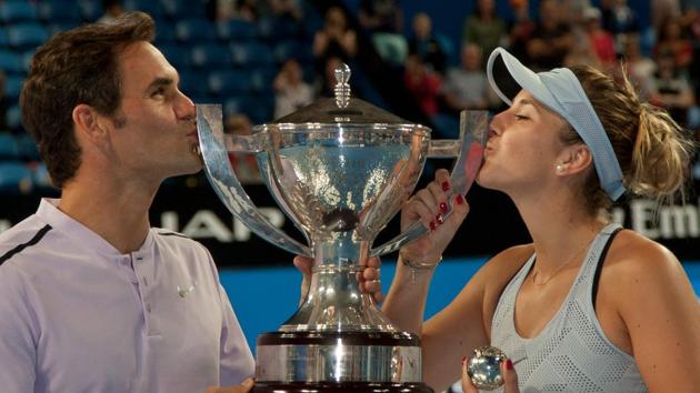 Roger Federer (L) and Belinda Bencic of Switzerland hoist the Hopman Cup after defeating Alexander Zverev and Angelique Kerber of Germany in the mixed doubles final on day eight of the Hopman Cup tennis tournament in Perth on January 6, 2018. (Tony Ashby / AFP) Roger Federer (L) and Belinda Bencic of Switzerland hoist the Hopman Cup after defeating Alexander Zverev and Angelique Kerber of Germany in the mixed doubles final on day eight of the Hopman Cup tennis tournament in Perth on January 6, 2018. (Tony Ashby / AFP)