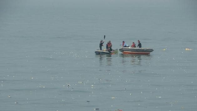 Indian Coast Guard personnel search for missing people off the coast of Mumbai after a helicopter crash on Saturday. (HT Photo)