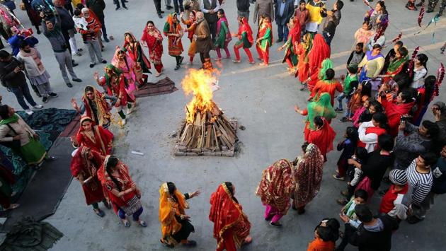 Women perform a traditional folk dance near a bonfire as they celebrate the Lohri festival, which marks the culmination of winter in many parts of northern India, in Jammu. (Mukesh Gupta / REUTERS)