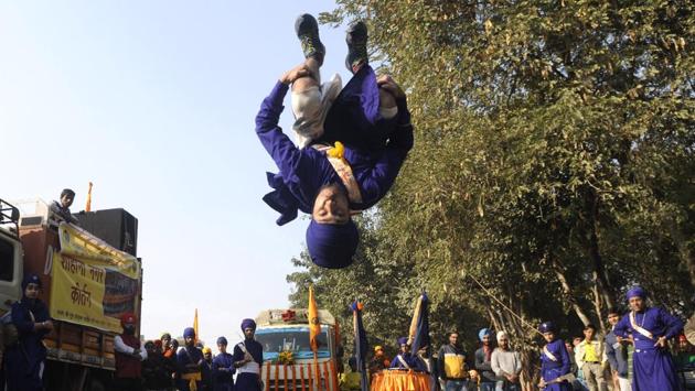 Sikh devotees display their martial arts skill during 'Nagar Kirtan' procession carried out as part of 'Prakash Utsav', in Noida on Sunday. (Sunil Ghosh / HT Photo) Sikh devotees display their martial arts skill during 'Nagar Kirtan' procession carried out as part of 'Prakash Utsav', in Noida on Sunday. (Sunil Ghosh / HT Photo)