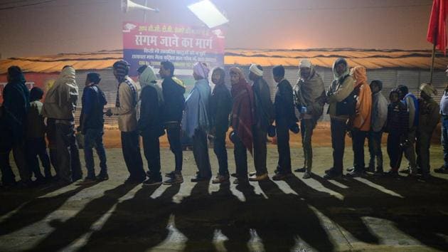Indian Hindu devotees stand in a queue outside a free meal distribution camp at Sangam, the confluence of the rivers Ganges, Yamuna and mythical Saraswati during the annual traditional fair of 'Magh Mela' in Allahabad. (Sanjay Kanojia / AFP)