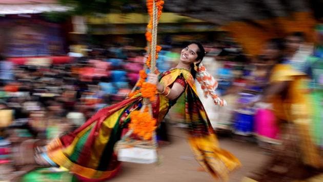 A student seen on a swing during celebrations for Pongal, the Tamil harvest festival, at a college in Chennai. (Arun Sankar / AFP)