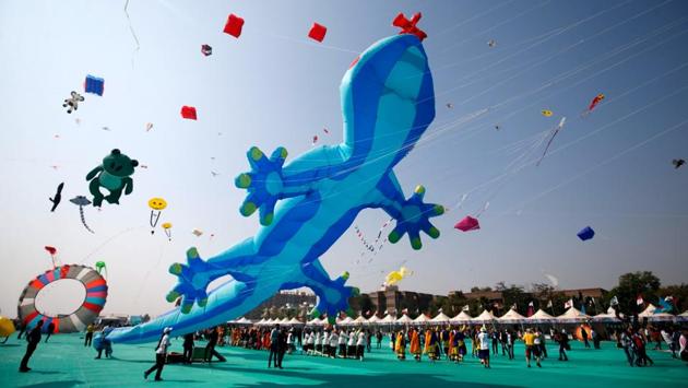 Kite-flying enthusiasts fly kites on the first day of the eight-day-long International Kite Festival in Ahmedabad. (Amit Dave/ REUTERS)