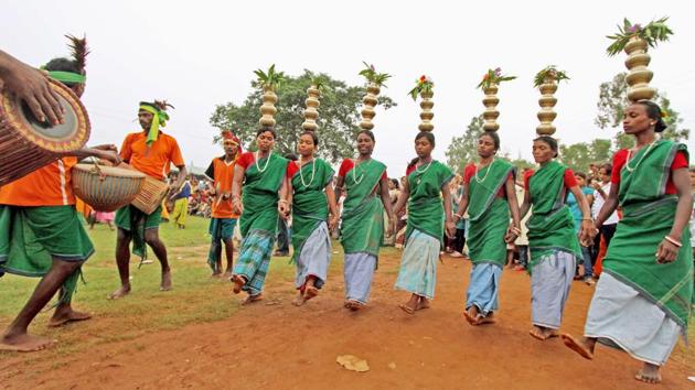 Tribals dance during the ‘Badna Parab’ festival on the eve of Maker Sankranti at Gopalnagar in Birbhum district of West Bengal. (PTI)