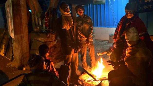 Homeless people warm themselves near a bonfire during the cold winter morning in New Delhi on January 9, 2017. (PTI) Homeless people warm themselves near a bonfire during the cold winter morning in New Delhi on January 9, 2017. (PTI)