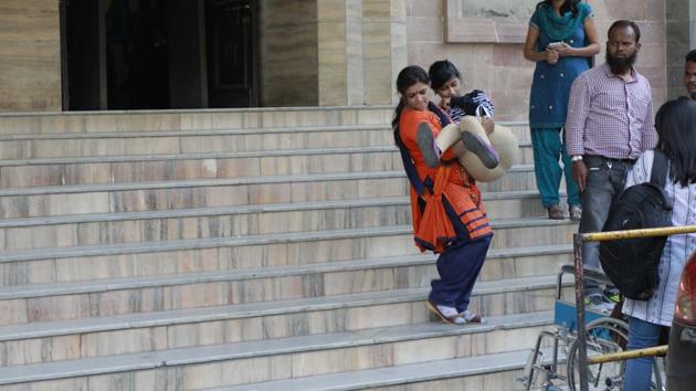 Twenty-four-year-old Diksha Dinde being carried down the staircase of the Pune Municipal Corporation (PMC) main building by her mother in the absence of a ramp.(HT File Photo) Twenty-four-year-old Diksha Dinde being carried down the staircase of the Pune Municipal Corporation (PMC) main building by her mother in the absence of a ramp.(HT File Photo)