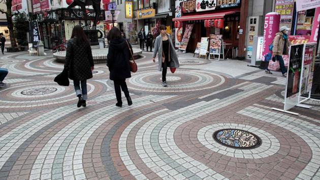 People walk past designed manhole covers in Kawaguchi. The craze has since spread online with abundant information on where to find the best manholes via the hashtag #manhotalk. (Behrouz Mehri / AFP) People walk past designed manhole covers in Kawaguchi. The craze has since spread online with abundant information on where to find the best manholes via the hashtag #manhotalk. (Behrouz Mehri / AFP)