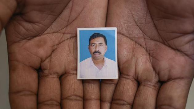 A passport photograph of Afrajul as held by his brother Rumkhan in Saiydpur in Malda. (Burhaan Kinu / HT Photo) A passport photograph of Afrajul as held by his brother Rumkhan in Saiydpur in Malda. (Burhaan Kinu / HT Photo)