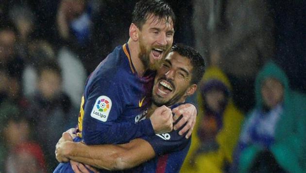 Barcelona’s Lionel Messi celebrates with Luis Suarez after scoring their fourth goal in La Liga against Real Sociedad at the Anoeta Stadium in San Sebastian on Sunday. (Reuters) Barcelona’s Lionel Messi celebrates with Luis Suarez after scoring their fourth goal in La Liga against Real Sociedad at the Anoeta Stadium in San Sebastian on Sunday. (Reuters)