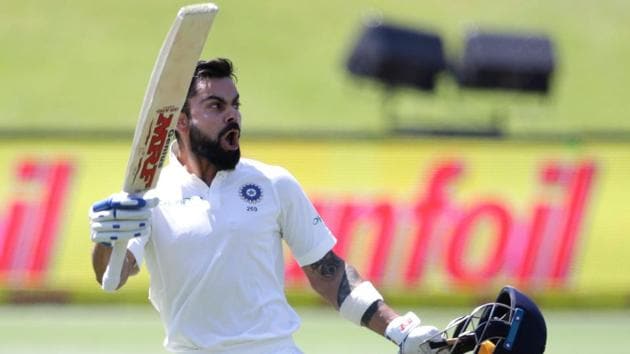 India's captain Virat Kohli raises his bat and helmet as he celebrates scoring a century during the third day of the second Test between South Africa and India at Centurion on January 15, 2018.(AFP)