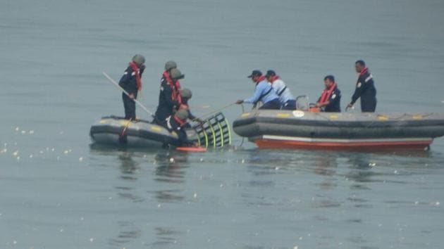 Coast Guard personnel looking for missing people following the chopper crash. (HT) Coast Guard personnel looking for missing people following the chopper crash. (HT)