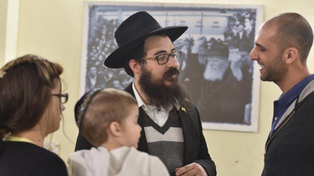 Akiva (C) and his wife Chaya (L) host programmes, activities and religious services for Israeli tourists and business travellers to Delhi. “They come here not just to seek my guidance on religious matters but also on finding hotels, dealing with situations like lost passports, and for kosher food. For them it is a home away from home,” he says, of the Chabad House located in a narrow lane in Paharganj. (Sanchit Khanna / HT Photo) Akiva (C) and his wife Chaya (L) host programmes, activities and religious services for Israeli tourists and business travellers to Delhi. “They come here not just to seek my guidance on religious matters but also on finding hotels, dealing with situations like lost passports, and for kosher food. For them it is a home away from home,” he says, of the Chabad House located in a narrow lane in Paharganj. (Sanchit Khanna / HT Photo)