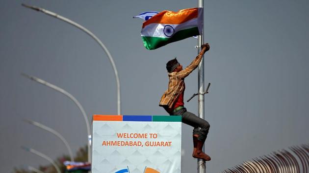 A man installs flags of India and Israel on a lamp post ahead of the visit of Israeli Prime Minister Benjamin Netanyahu to Ahmedabad.(REUTERS)