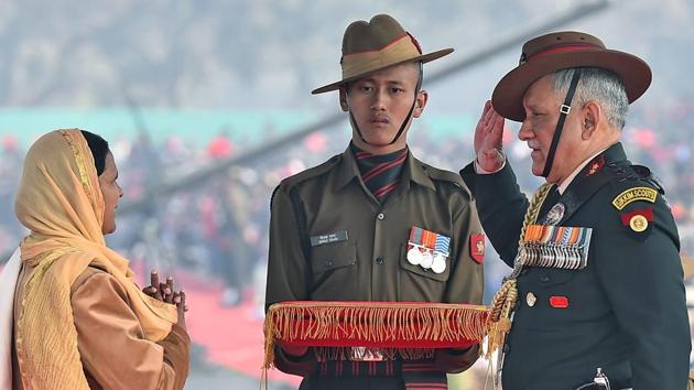 Army Chief Gen Bipin Rawat salutes the widow of an army martyr after honouring her at the Army Day parade. He also awarded the Sena Medal to a number of Army personnel. (Kamal Singh / PTI)