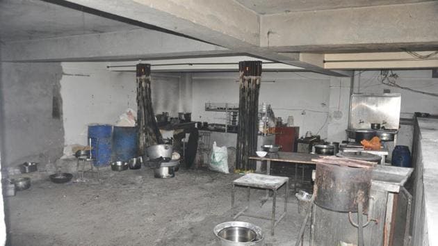 A basement parking in a commercial complex on Chakrata Road in Dehradun being used as a kitchen.(Vinay Santosh Kumar/HT Photo)