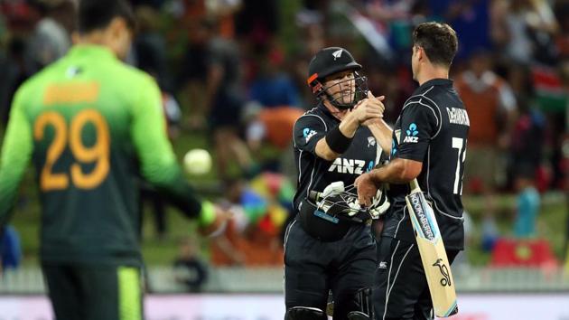 New Zealand cricket team's Henry Nicholls (C) and Colin de Grandhomme (R) celebrate after beating Pakistan cricket team in the fourth one-day international at Seddon Park in Hamilton on Tuesday. (AFP) New Zealand cricket team's Henry Nicholls (C) and Colin de Grandhomme (R) celebrate after beating Pakistan cricket team in the fourth one-day international at Seddon Park in Hamilton on Tuesday. (AFP)