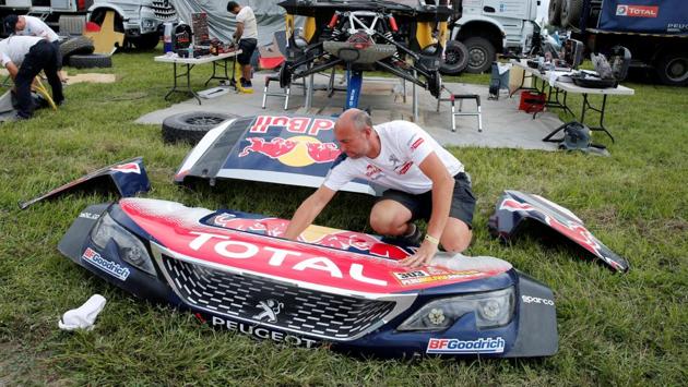 A mechanic works on one of the Peugeot cars in Salta after the day’s Dakar Rally action (ninth stage) was suspended following rain and mudslide. (REUTERS) A mechanic works on one of the Peugeot cars in Salta after the day’s Dakar Rally action (ninth stage) was suspended following rain and mudslide. (REUTERS)