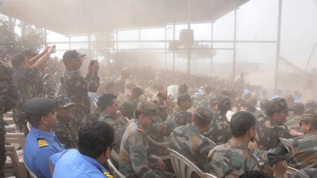 Dust surrounds around the spectators during a Army fire drill at KK Range, Ahmednagar. (HT PHOTO) 