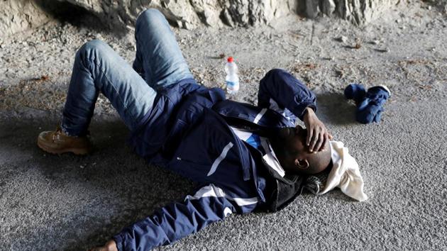 Abdullhai, rests after crossing into France near the town of Nevache. In Guinea, he left behind his wife and three children, including a two-year-old whom he has never seen. “There is no work there and no future for my children. Here in Europe we can have a future. We can find work and live a life with some dignity. This is worth a try for me.” (Siegfried Modola / Reuters) Abdullhai, rests after crossing into France near the town of Nevache. In Guinea, he left behind his wife and three children, including a two-year-old whom he has never seen. “There is no work there and no future for my children. Here in Europe we can have a future. We can find work and live a life with some dignity. This is worth a try for me.” (Siegfried Modola / Reuters)