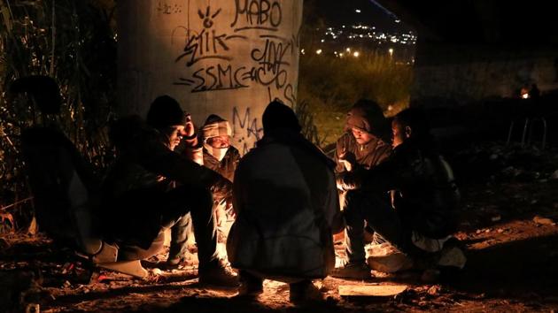 Migrants mostly from the Darfur region of western Sudan warm up by a fire under a highway bypass in Ventimiglia where they have been sheltering in preparation to attempt the crossing into France. (Siegfried Modola / Reuters) Migrants mostly from the Darfur region of western Sudan warm up by a fire under a highway bypass in Ventimiglia where they have been sheltering in preparation to attempt the crossing into France. (Siegfried Modola / Reuters)