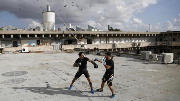 Instructors Doron Turgeman (L), 35, and Michael Alimelech, 26, train on the rooftop of the building in which they give courses, as part of their Krav Maga, an Israeli self-defence technique, in the city of Givatayim, east of Tel Aviv. (Corinna Kern / REUTERS)