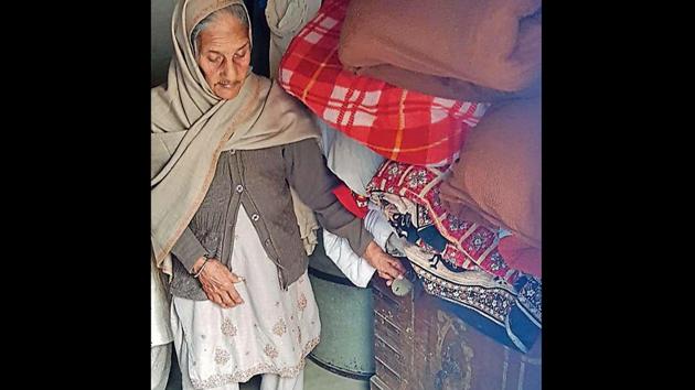 Gurdayal Kaur stands next to the wooden box in which she has kept the body of her grandson at Hathur village near Jagraon on Tuesday. (HT Photo) Gurdayal Kaur stands next to the wooden box in which she has kept the body of her grandson at Hathur village near Jagraon on Tuesday. (HT Photo)