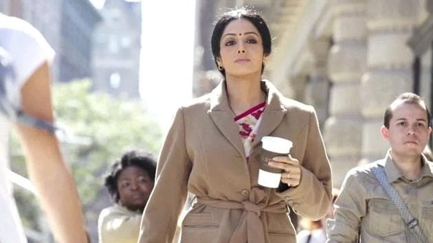 A still from the 2012 film English Vinglish. Sridevi look chic in a sari paired with a long coat.