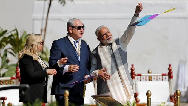 Prime Minister Narendra Modi flies a kite watched by Benjamin and Sara Netanyahu. (Amit Dave / REUTERS)