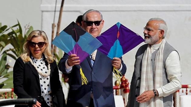 Benjamin Netanyahu holds kites as his wife Sara and PM Narendra Modi look on at Gandhi Ashram. The two leaders are scheduled to visit a centre for agriculture in Sabarkantha. (Amit Dave / REUTERS)