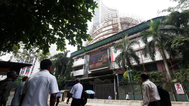 People walk past the Bombay Stock Exchange (BSE) building in Mumbai. Benchmark Sensex soared over 310 points to close above the 35,000-mark for the first time ever, while the broader Nifty too ended at a fresh life-time high on unabated buying by participants. (Shailesh Andrade / REUTERS) People walk past the Bombay Stock Exchange (BSE) building in Mumbai. Benchmark Sensex soared over 310 points to close above the 35,000-mark for the first time ever, while the broader Nifty too ended at a fresh life-time high on unabated buying by participants. (Shailesh Andrade / REUTERS)