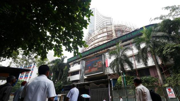 People walk past the Bombay Stock Exchange (BSE) building in Mumbai. (REUTERS) People walk past the Bombay Stock Exchange (BSE) building in Mumbai. (REUTERS)