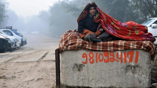 A homeless man wraps himself in a blanket against the cold in New Delhi. The mercury dropped to 5.6 degrees Celsius today morning, affecting train operations in the capital. The dense fog is expected to persist for another day, before giving way to shallow fog and then later mist. (Arun Sharma / PTI) A homeless man wraps himself in a blanket against the cold in New Delhi. The mercury dropped to 5.6 degrees Celsius today morning, affecting train operations in the capital. The dense fog is expected to persist for another day, before giving way to shallow fog and then later mist. (Arun Sharma / PTI)